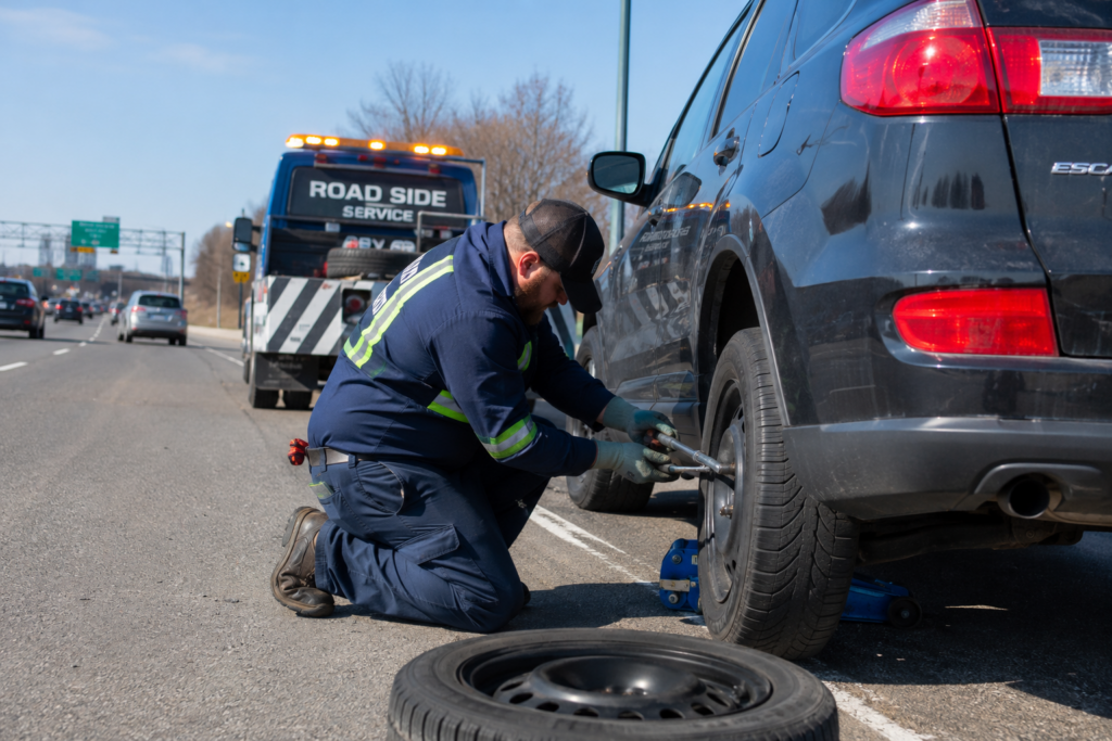 A man performing flat tire service in Maryland heights.